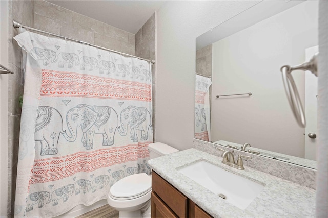 bathroom featuring curtained shower, toilet, and vanity