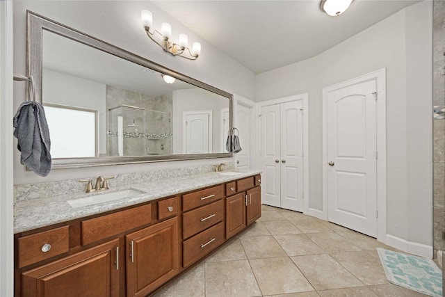 bathroom with vanity, a shower with shower door, and tile patterned flooring