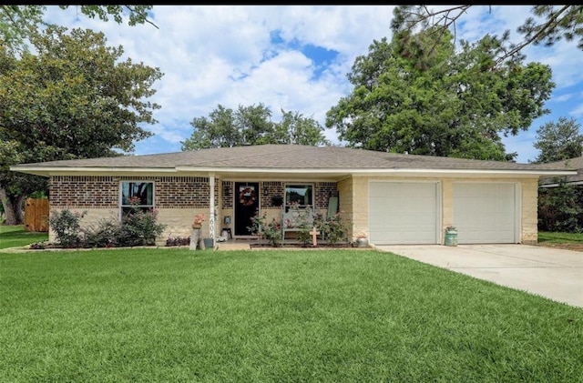 606 S Kaufman Dr, Deer Park, TX 77536 - ranch-style home with concrete driveway, a front lawn, an attached garage, and brick siding