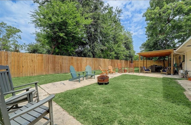 view of yard featuring a patio and a fire pit