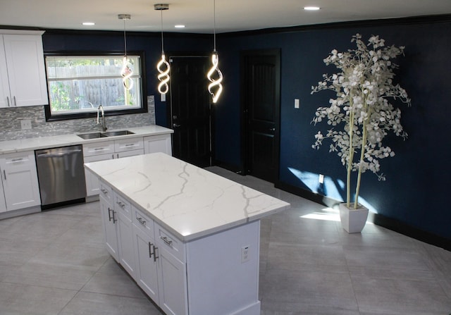 kitchen featuring white cabinets, a kitchen island, tasteful backsplash, sink, and stainless steel dishwasher