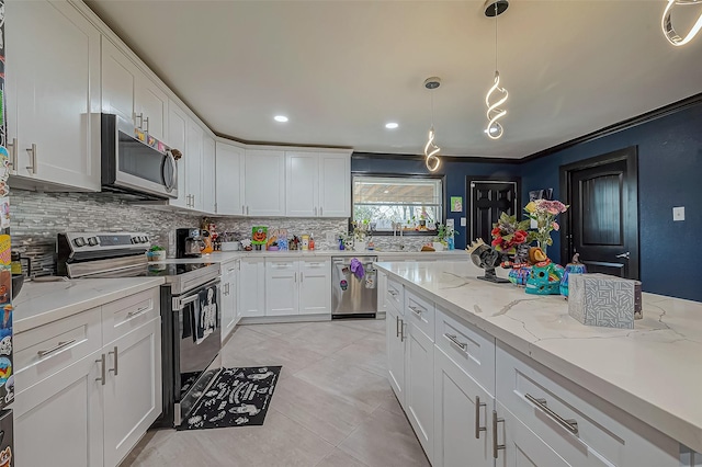 606 S Kaufman Dr, Deer Park, TX 77536 - kitchen with pendant lighting, stainless steel appliances, tasteful backsplash, and white cabinets