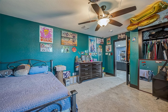 606 S Kaufman Dr, Deer Park, TX 77536 - carpeted bedroom featuring a ceiling fan, visible vents, a closet, and a textured wall