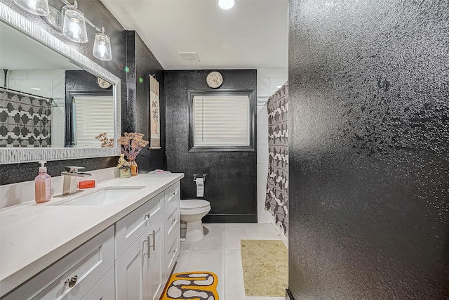 606 S Kaufman Dr, Deer Park, TX 77536 - bathroom with toilet, visible vents, vanity, a tile shower, and tile patterned floors