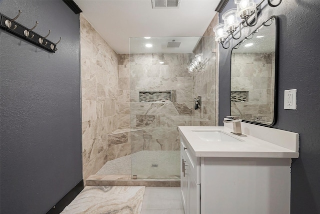 606 S Kaufman Dr, Deer Park, TX 77536 - full bathroom featuring a textured wall, visible vents, tiled shower, and vanity