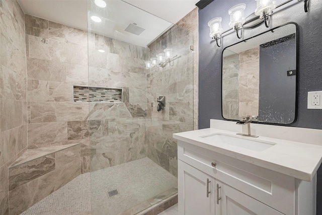 606 S Kaufman Dr, Deer Park, TX 77536 - bathroom featuring a textured wall, vanity, and walk in shower