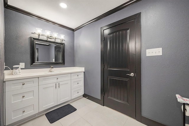 606 S Kaufman Dr, Deer Park, TX 77536 - bathroom with a textured wall, tile patterned floors, vanity, and crown molding