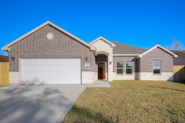 view of front of home with a front yard and a garage