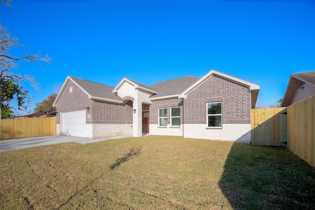 ranch-style home featuring a front lawn and a garage