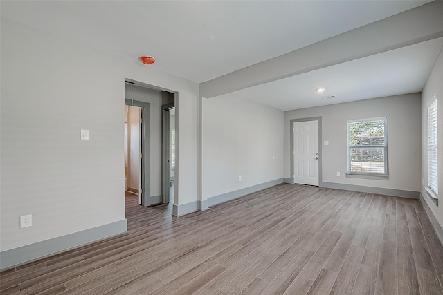 unfurnished room with light hardwood / wood-style floors