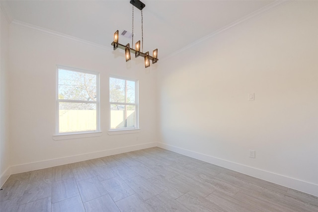 unfurnished room with an inviting chandelier and ornamental molding