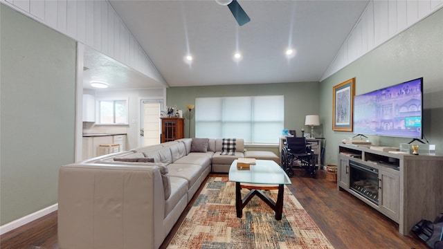 living room featuring ceiling fan, dark wood-type flooring, and vaulted ceiling