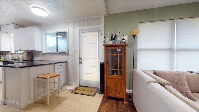 kitchen featuring white cabinetry and a textured ceiling