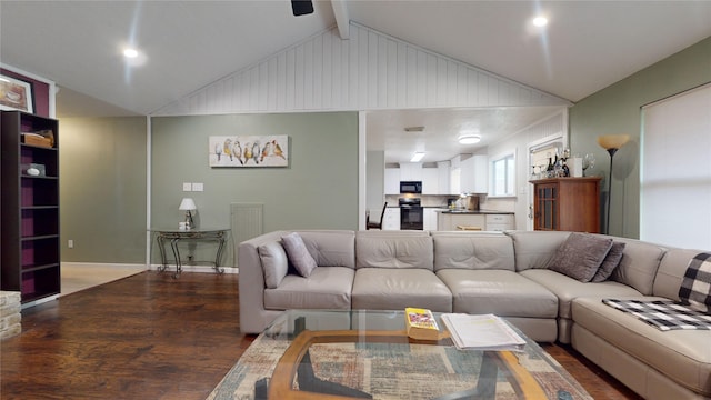 living room featuring vaulted ceiling with beams and wood-type flooring