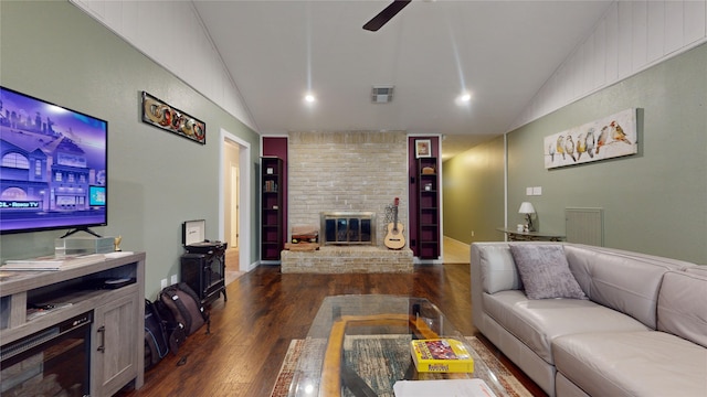 living room with a fireplace, dark hardwood / wood-style flooring, ceiling fan, and lofted ceiling