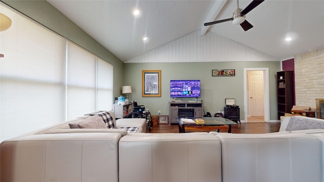 living room with hardwood / wood-style floors, vaulted ceiling with beams, and ceiling fan