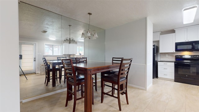 dining room featuring a chandelier and a textured ceiling