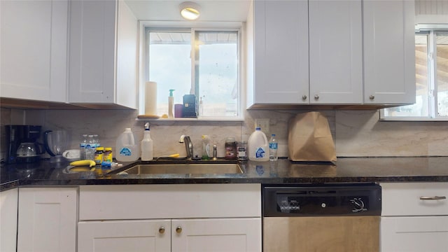 kitchen with a wealth of natural light, white cabinetry, dishwasher, sink, and tasteful backsplash