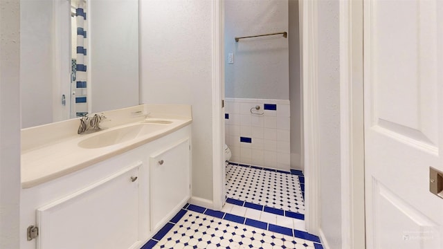 bathroom featuring tile patterned floors, vanity, and toilet