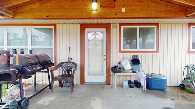 view of exterior entry featuring a patio area