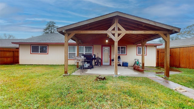 back of property featuring a lawn and a patio