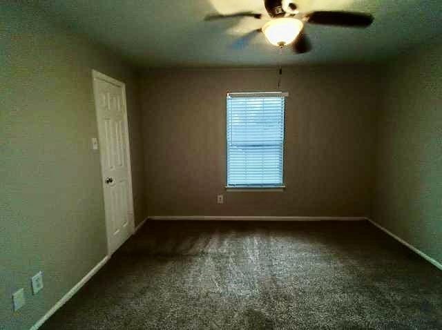 carpeted empty room with ceiling fan