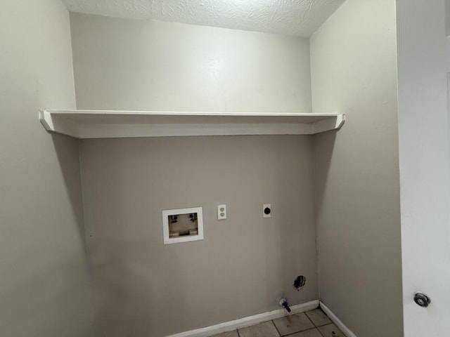 clothes washing area featuring washer hookup, light tile patterned floors, a textured ceiling, and electric dryer hookup