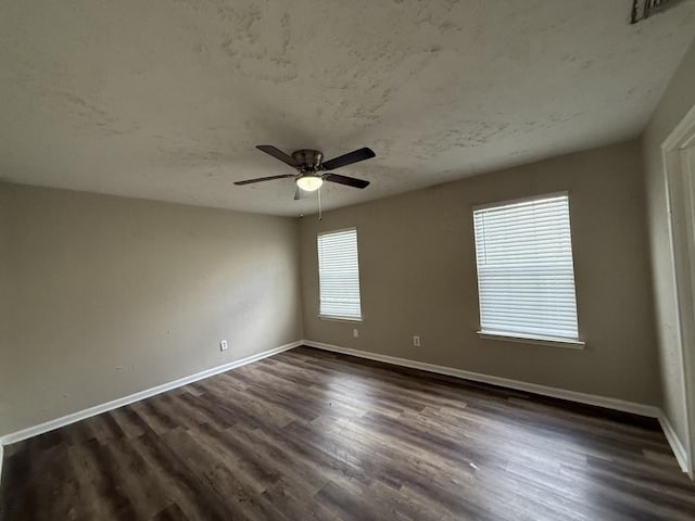 spare room with dark hardwood / wood-style flooring, a textured ceiling, and ceiling fan