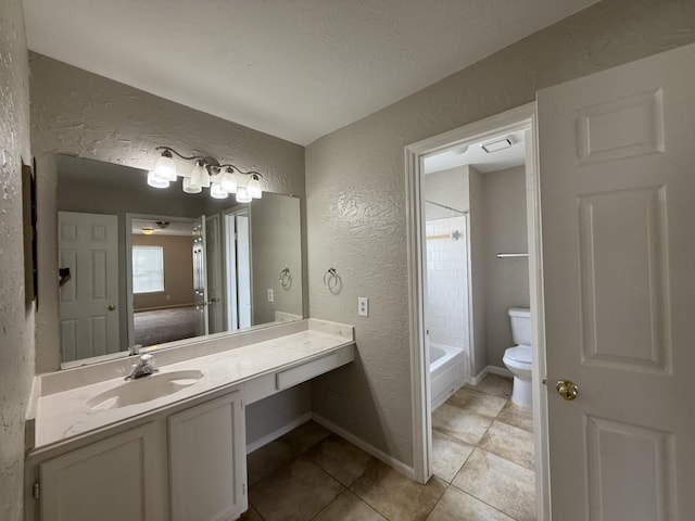 full bathroom with vanity, tile patterned floors, toilet, and tiled shower / bath