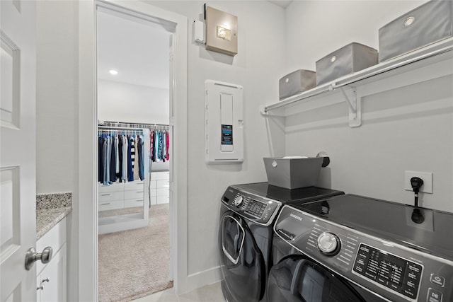 laundry area with separate washer and dryer, electric panel, and light colored carpet