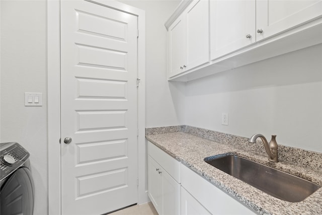 washroom featuring cabinets, washer / dryer, and sink