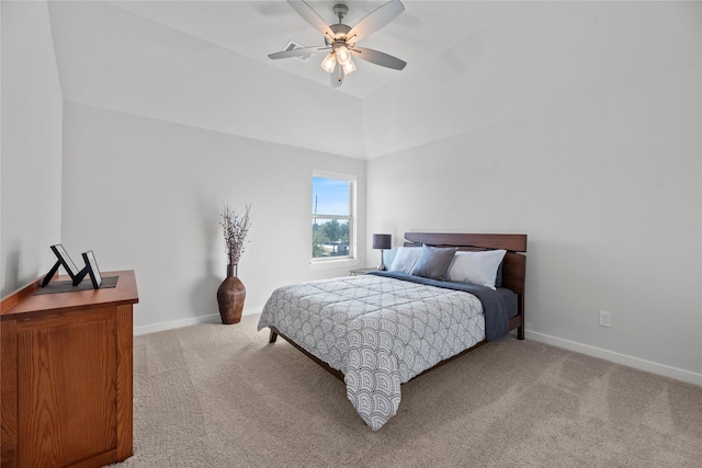 carpeted bedroom with ceiling fan and vaulted ceiling