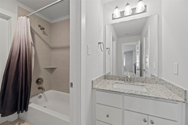 bathroom featuring shower / bath combo and vanity