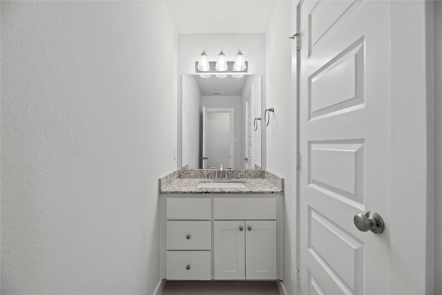 bathroom with tile patterned flooring and vanity