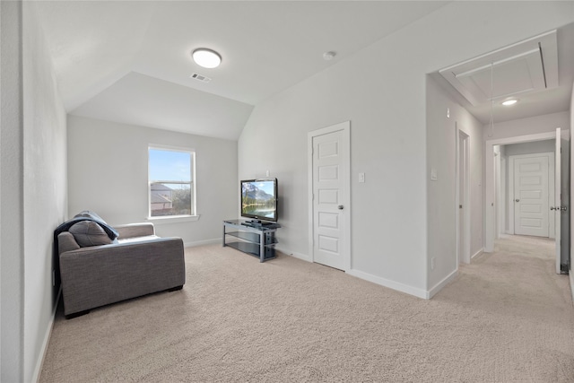 carpeted living room with vaulted ceiling