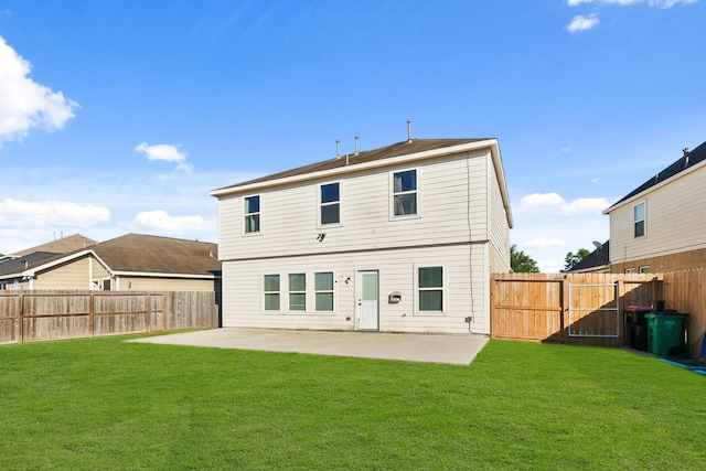 rear view of property with a yard and a patio