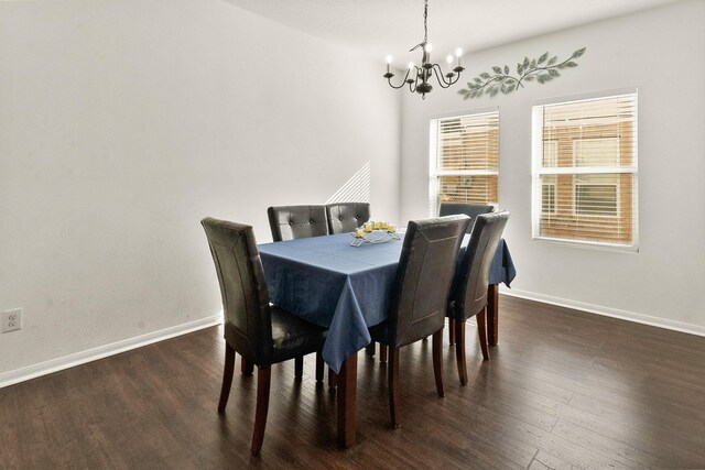 dining room featuring a notable chandelier and dark hardwood / wood-style flooring