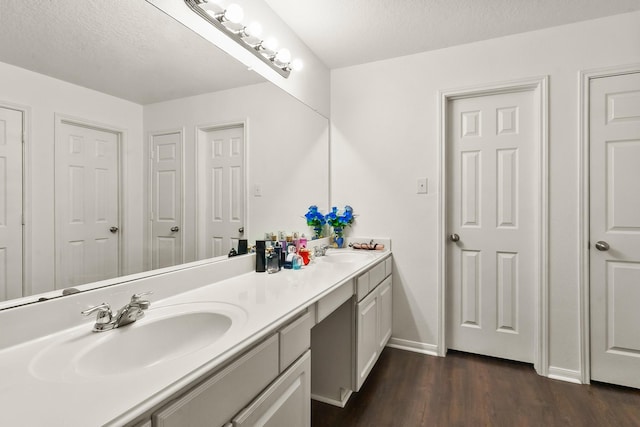 bathroom featuring a textured ceiling, vanity, and hardwood / wood-style flooring