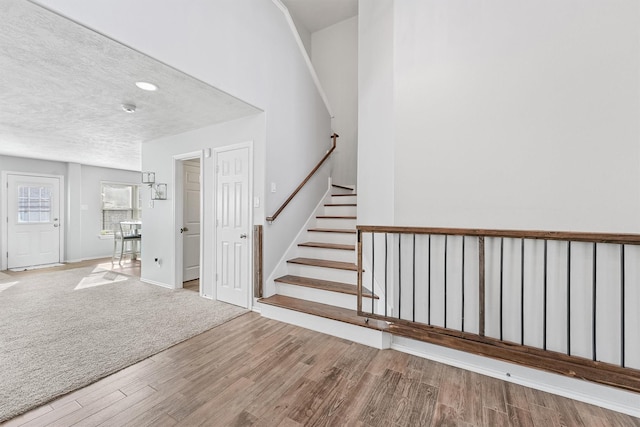 entrance foyer featuring wood-type flooring and a textured ceiling