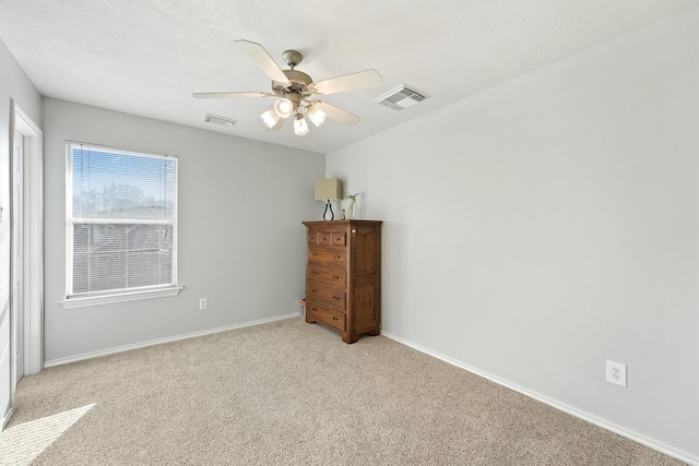 unfurnished bedroom featuring ceiling fan and light colored carpet