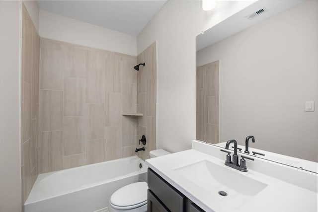 full bathroom featuring vanity, tiled shower / bath combo, and toilet