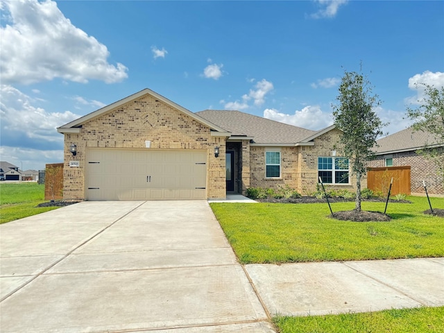 ranch-style house featuring a garage and a front lawn