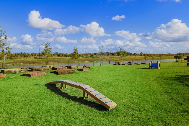 view of home's community with a rural view and a yard