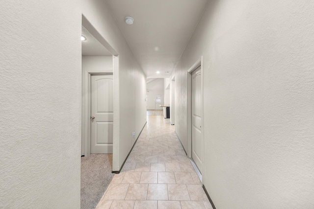 corridor with light tile patterned flooring