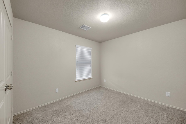 empty room featuring carpet floors and a textured ceiling