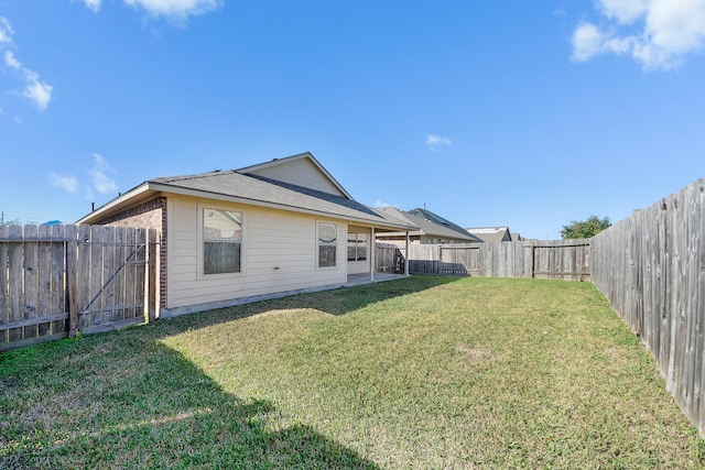 rear view of property with a lawn