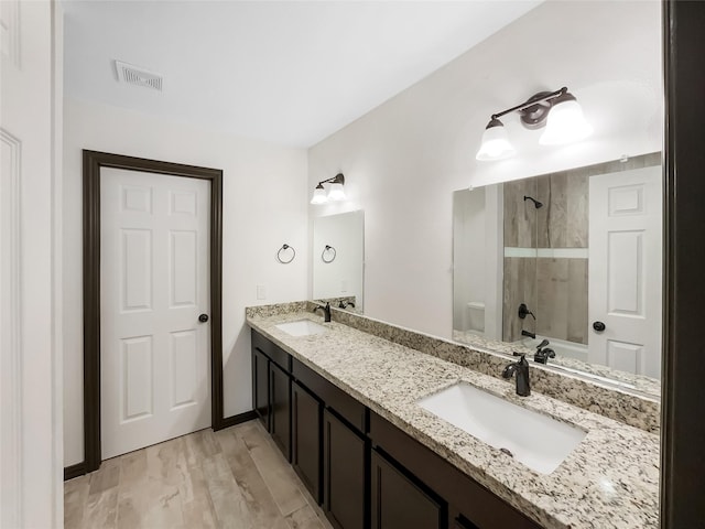 full bathroom featuring wood-type flooring, vanity, toilet, and tub / shower combination