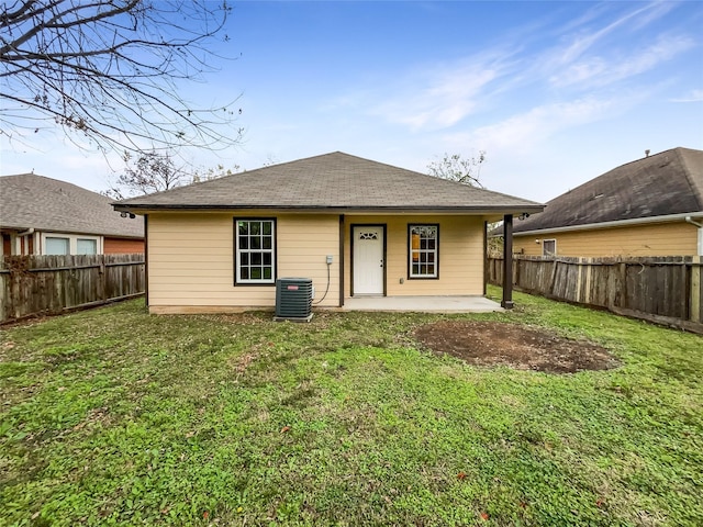 back of house featuring central AC, a patio area, and a yard