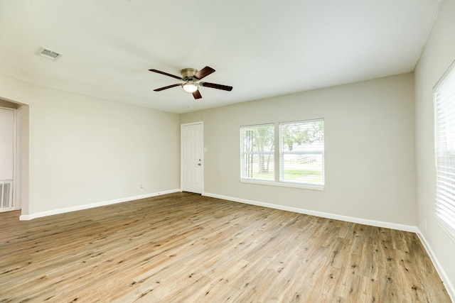 spare room featuring plenty of natural light, ceiling fan, and light hardwood / wood-style flooring