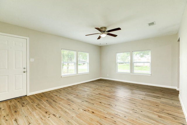 empty room with ceiling fan and light hardwood / wood-style floors